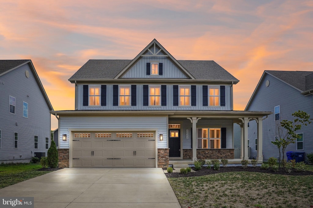 craftsman house with a yard, a garage, and covered porch