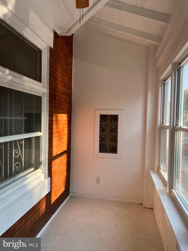 interior space with lofted ceiling with beams and wood ceiling