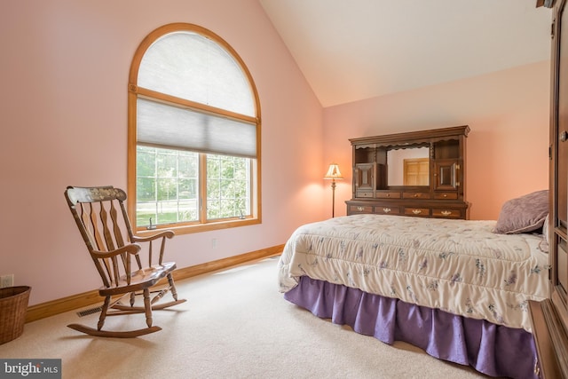 bedroom with high vaulted ceiling and carpet flooring