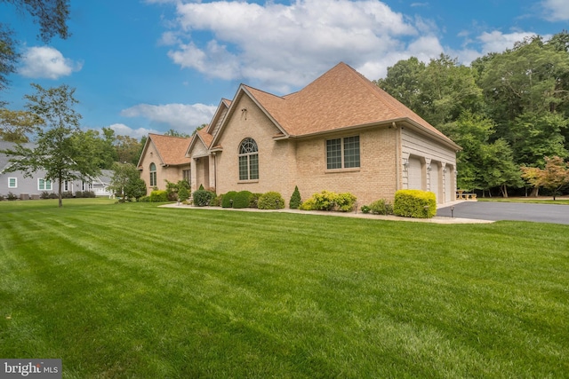 view of front of property with a garage and a front yard