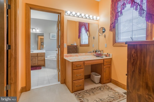 bathroom featuring a relaxing tiled tub, tile patterned flooring, and vanity