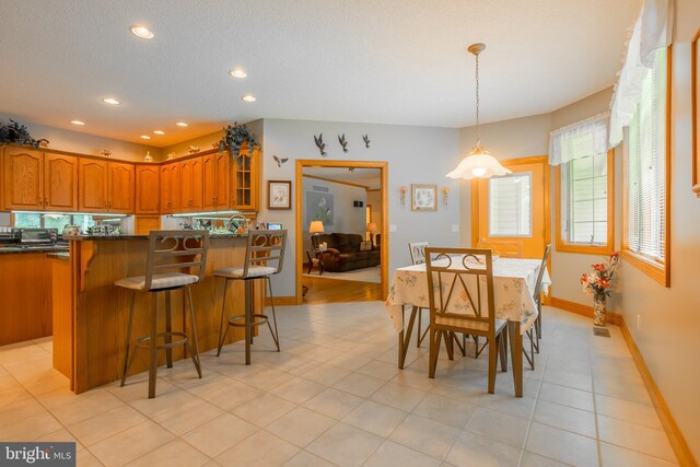 dining area with light tile patterned flooring, baseboards, visible vents, recessed lighting, and a textured ceiling