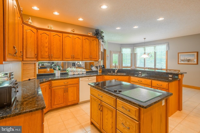 kitchen with a kitchen island, dishwasher, pendant lighting, and light tile patterned flooring