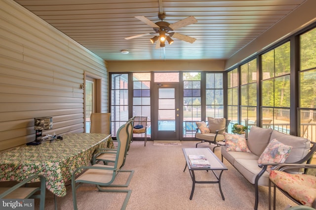 sunroom featuring ceiling fan