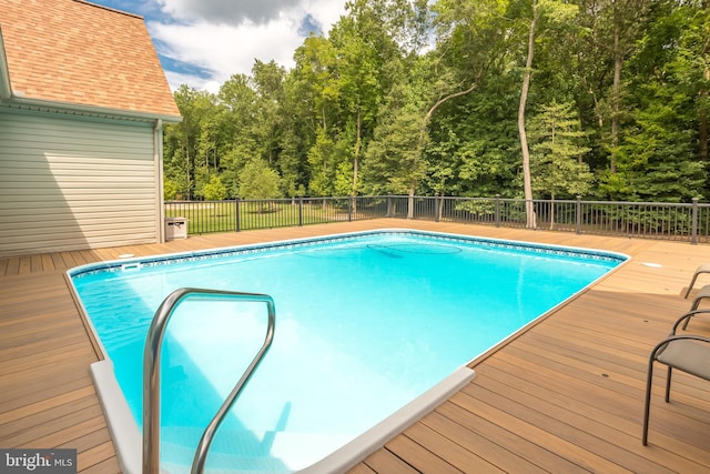 view of pool with a wooden deck