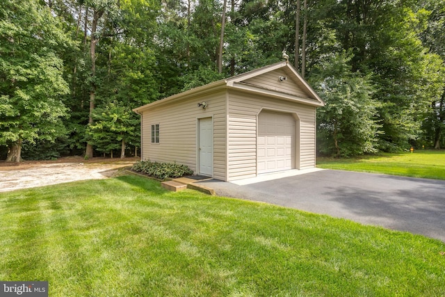 garage featuring a lawn