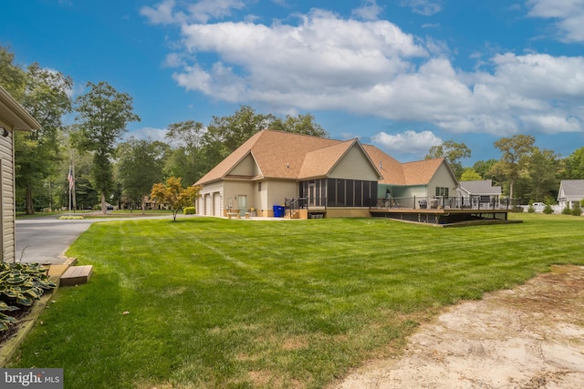 view of yard featuring a deck and a sunroom