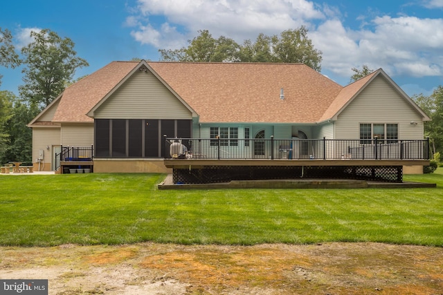 back of house featuring a deck, a sunroom, and a yard