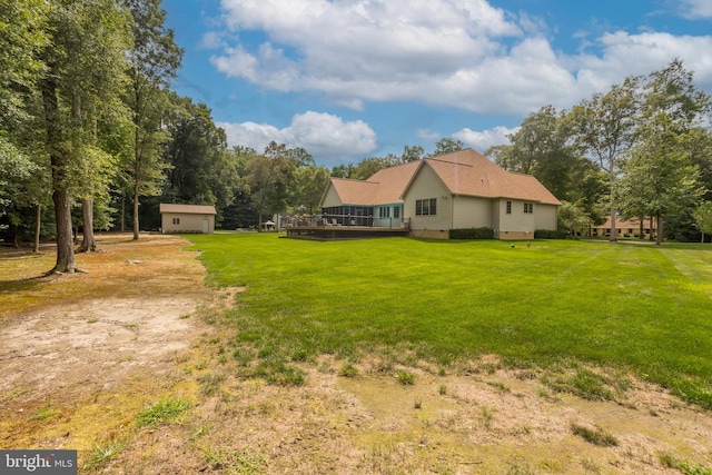 view of yard with a garage and an outbuilding