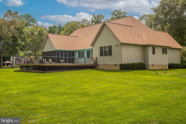 rear view of property featuring a wooden deck and a yard