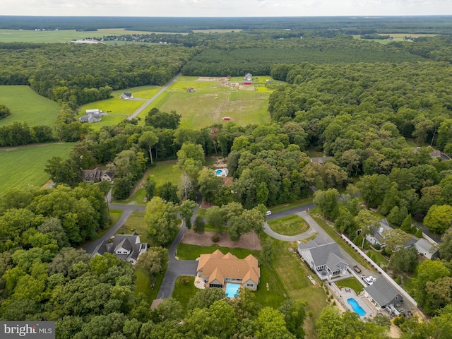 birds eye view of property with a forest view