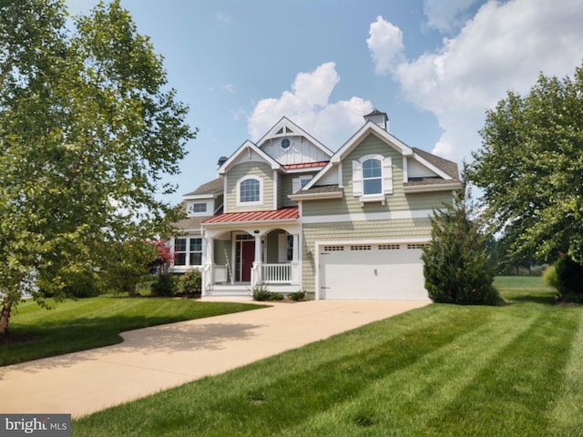 view of front of home featuring a front lawn, a porch, and a garage