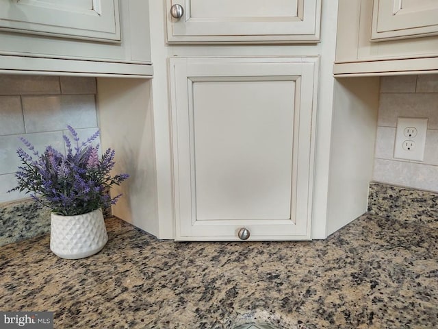 details featuring decorative backsplash and stone counters