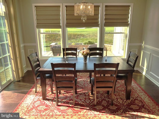 dining room featuring a wealth of natural light, an inviting chandelier, and wood finished floors