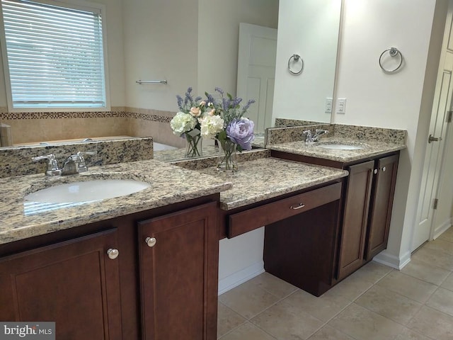 bathroom featuring tile patterned flooring, two vanities, and a sink