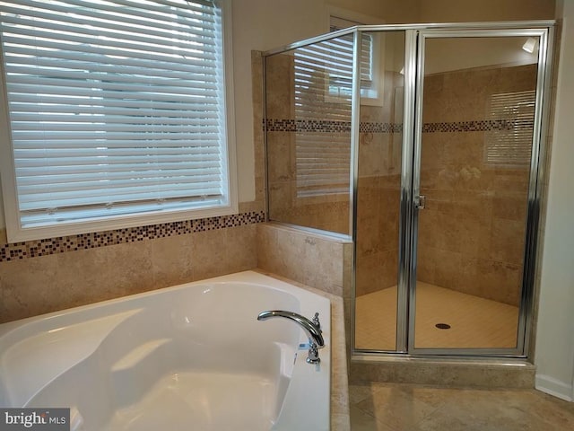 bathroom featuring a garden tub and a stall shower