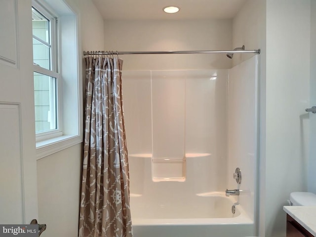 bathroom featuring vanity and shower / bathtub combination with curtain