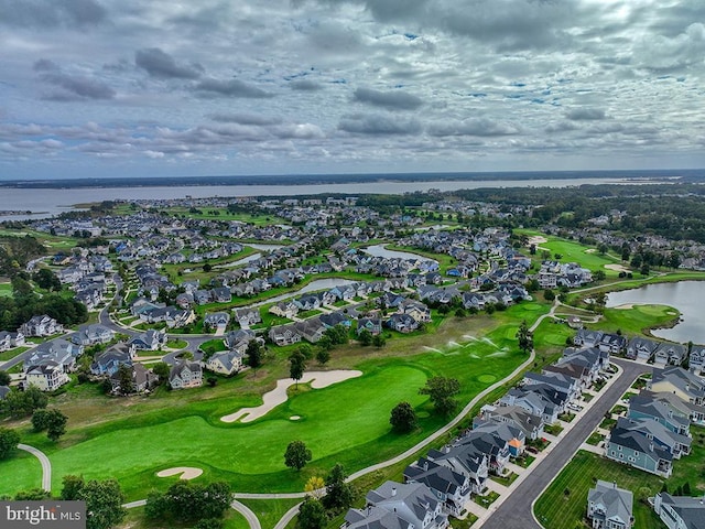 birds eye view of property with a residential view, view of golf course, and a water view