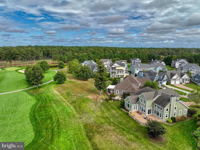 drone / aerial view featuring a residential view and a view of trees