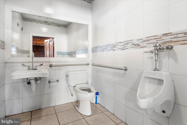 bathroom featuring decorative backsplash, toilet, tile patterned flooring, sink, and tile walls