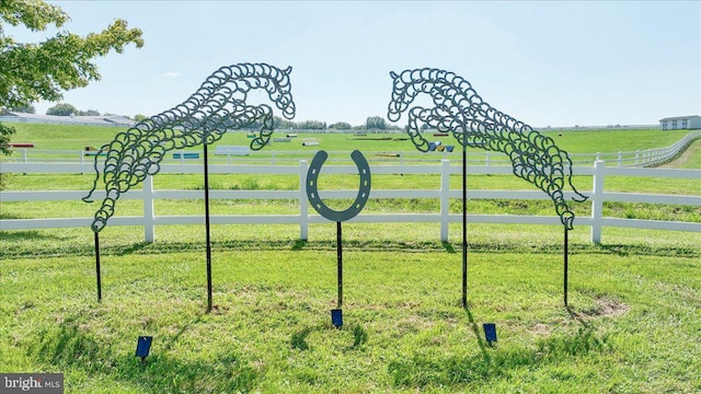 view of gate featuring a yard and a rural view