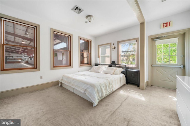 bedroom featuring light carpet, visible vents, and baseboards