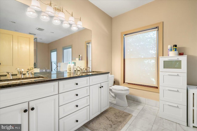 full bathroom with double vanity, visible vents, toilet, and a sink