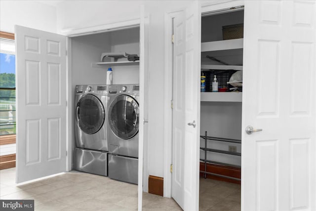 washroom with laundry area, light tile patterned floors, and separate washer and dryer