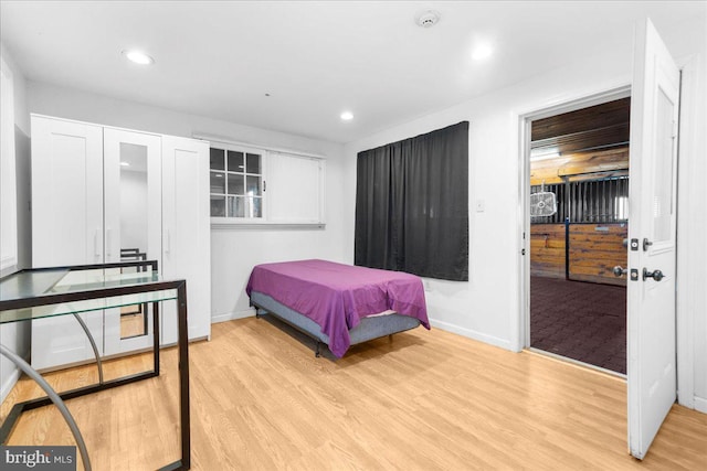 bedroom with recessed lighting, baseboards, and light wood-type flooring