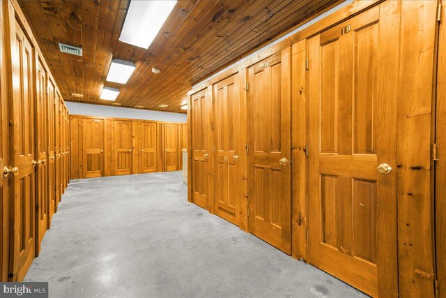 laundry room with sink, water heater, washer and dryer, and wooden walls