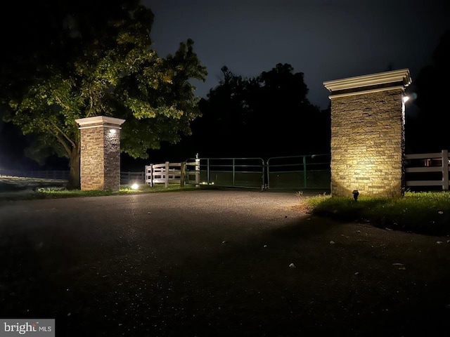 gate at twilight featuring fence