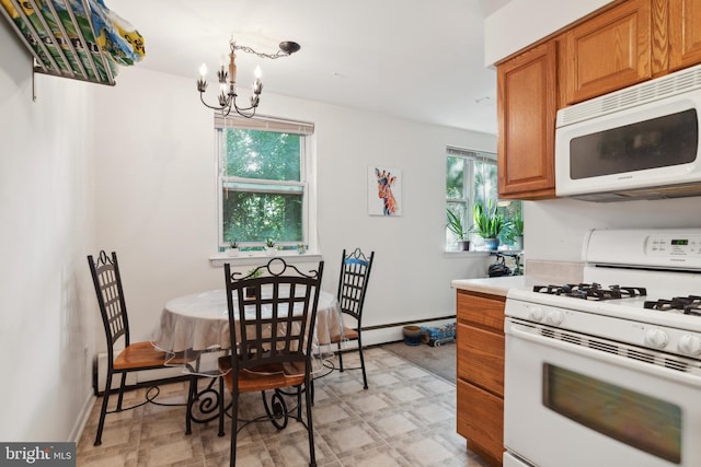 kitchen with white appliances, pendant lighting, a chandelier, and light tile patterned floors