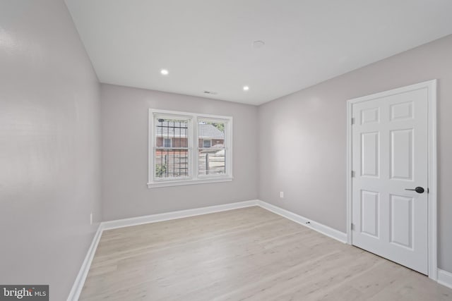 spare room featuring light hardwood / wood-style flooring