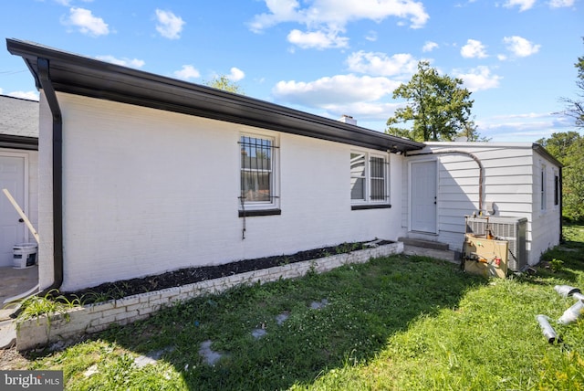 view of property exterior featuring cooling unit and a yard