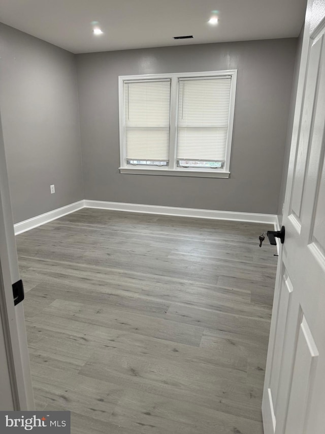 unfurnished room featuring hardwood / wood-style floors