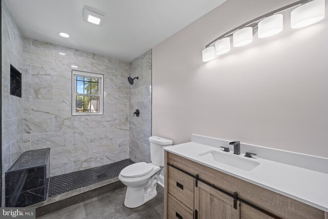 bathroom with tiled shower and toilet