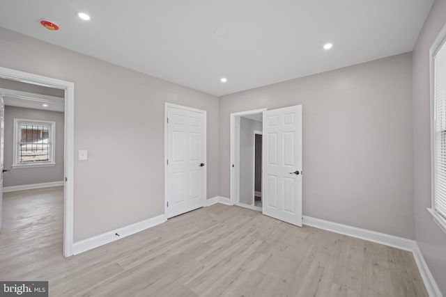 unfurnished room with light hardwood / wood-style floors