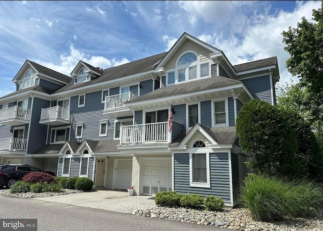 view of front of property with a balcony and a garage