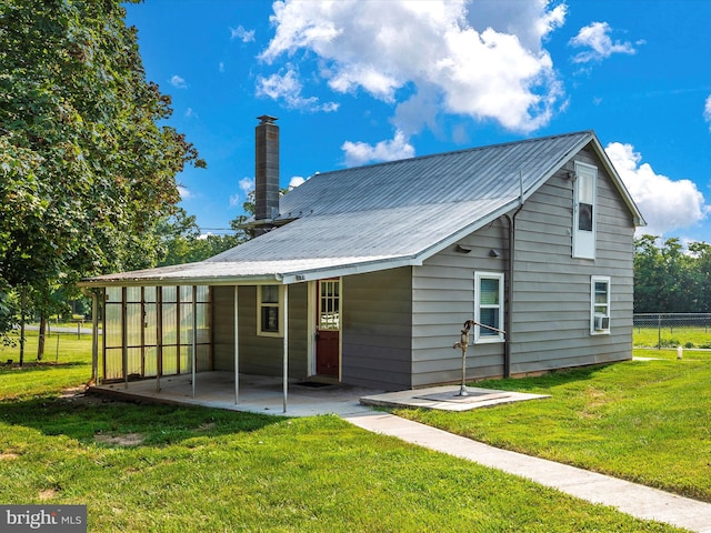 back of house featuring a patio and a yard