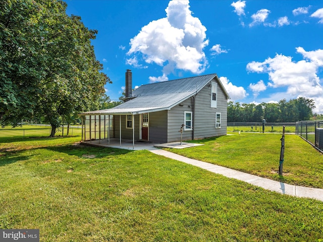 back of property with a patio and a yard