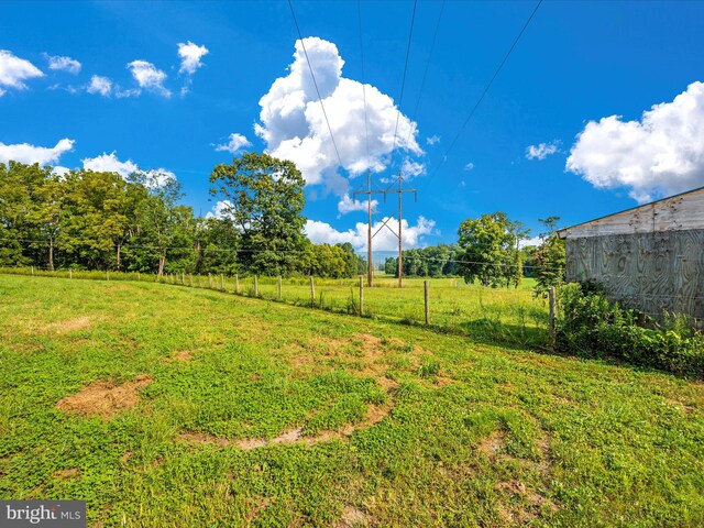 view of yard with a rural view