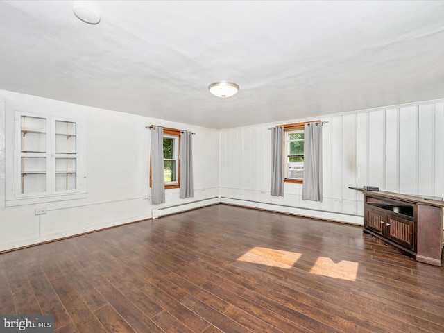 interior space with a baseboard heating unit and dark wood-type flooring