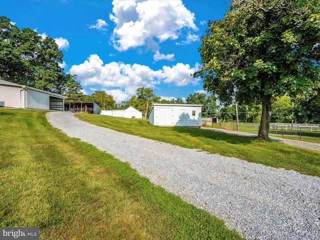 view of front facade with a front lawn and an outdoor structure