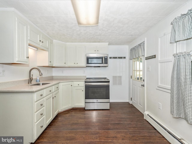 kitchen with white cabinets, stainless steel appliances, a baseboard radiator, dark hardwood / wood-style floors, and sink