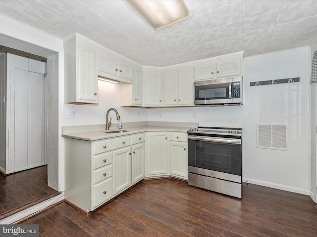 kitchen with white cabinetry, dark hardwood / wood-style flooring, sink, and stainless steel appliances