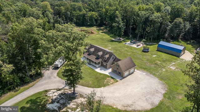 birds eye view of property with a forest view