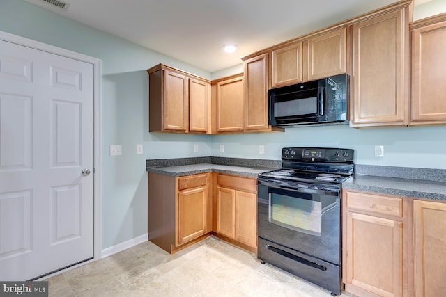 kitchen with dark countertops, baseboards, and black appliances