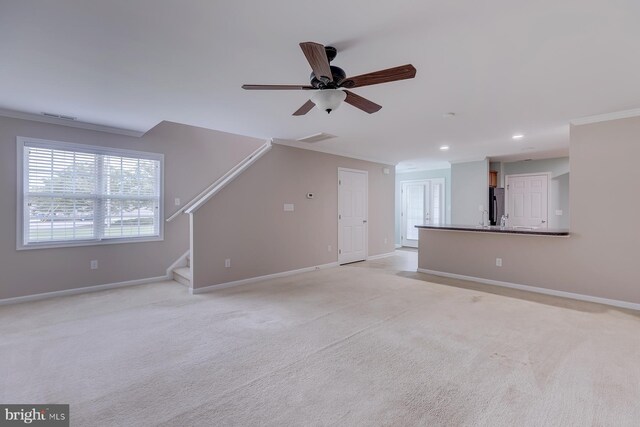 interior space featuring ceiling fan and light carpet