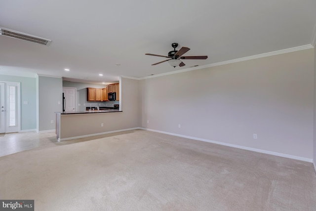 unfurnished living room featuring ornamental molding, visible vents, light carpet, and baseboards