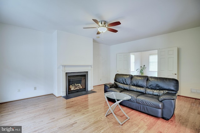 living room with ceiling fan and light hardwood / wood-style floors